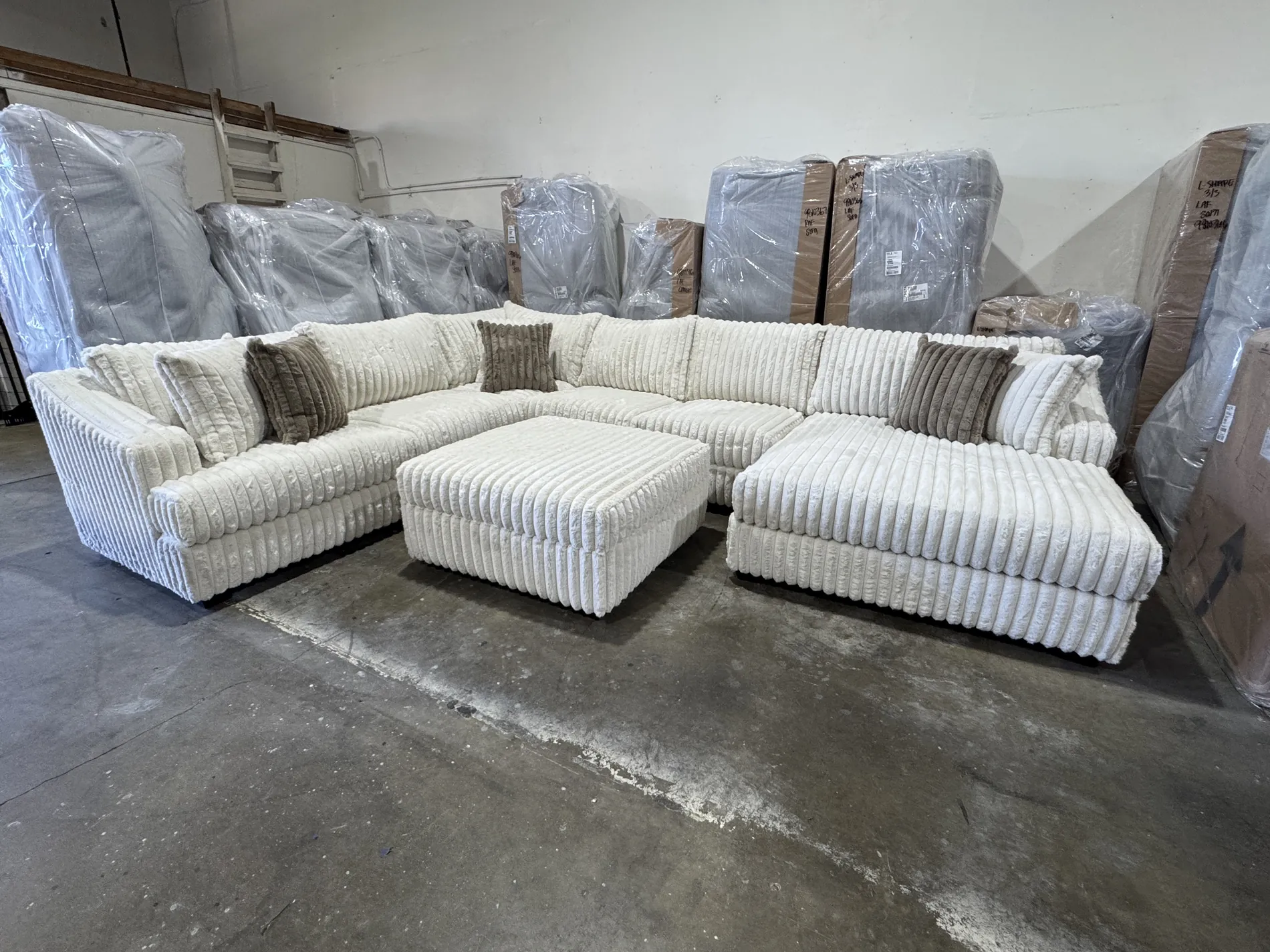 Custom cream channel sectional with ottoman
