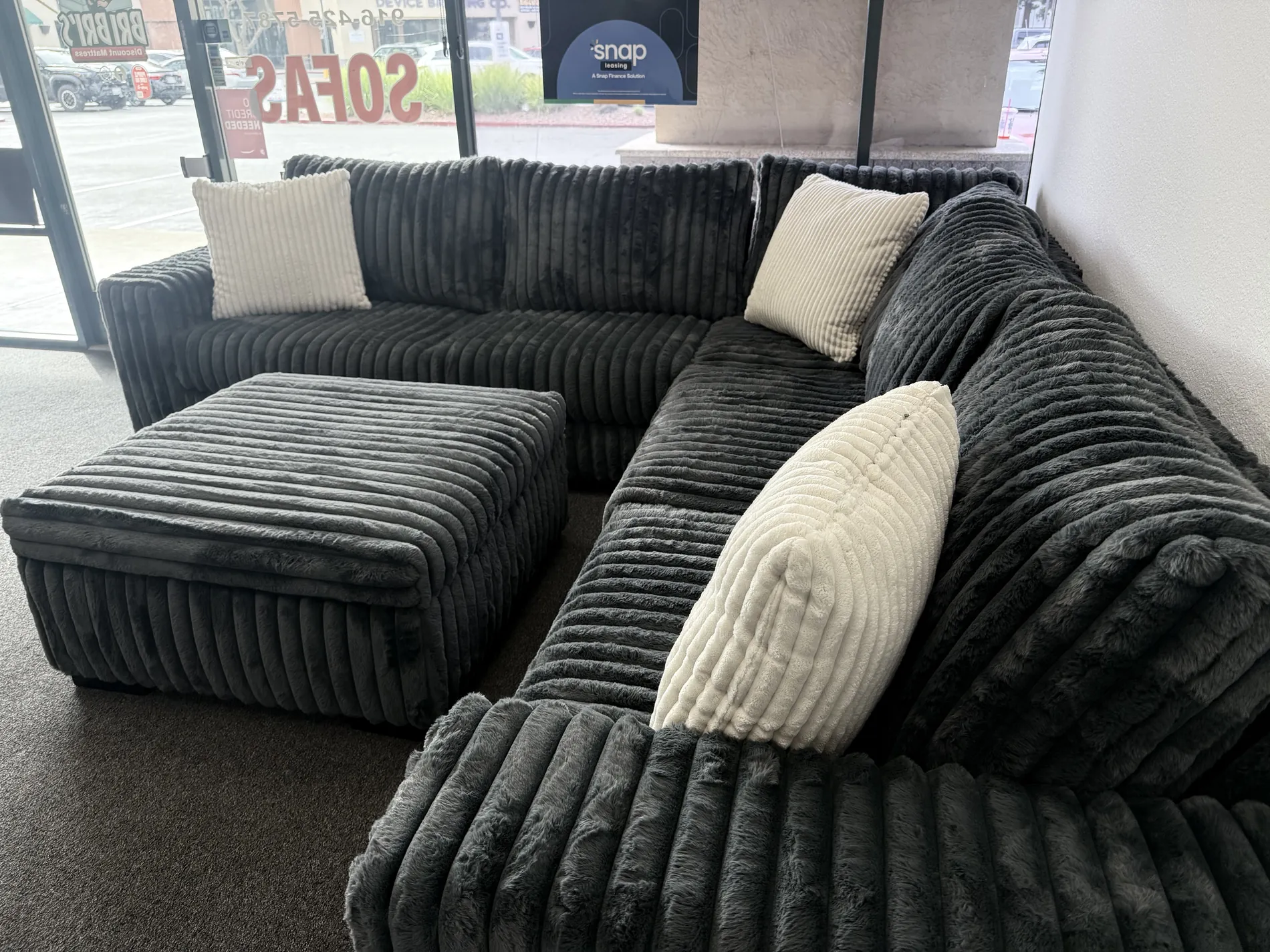 Black plush sectional on the BriBri's showroom floor